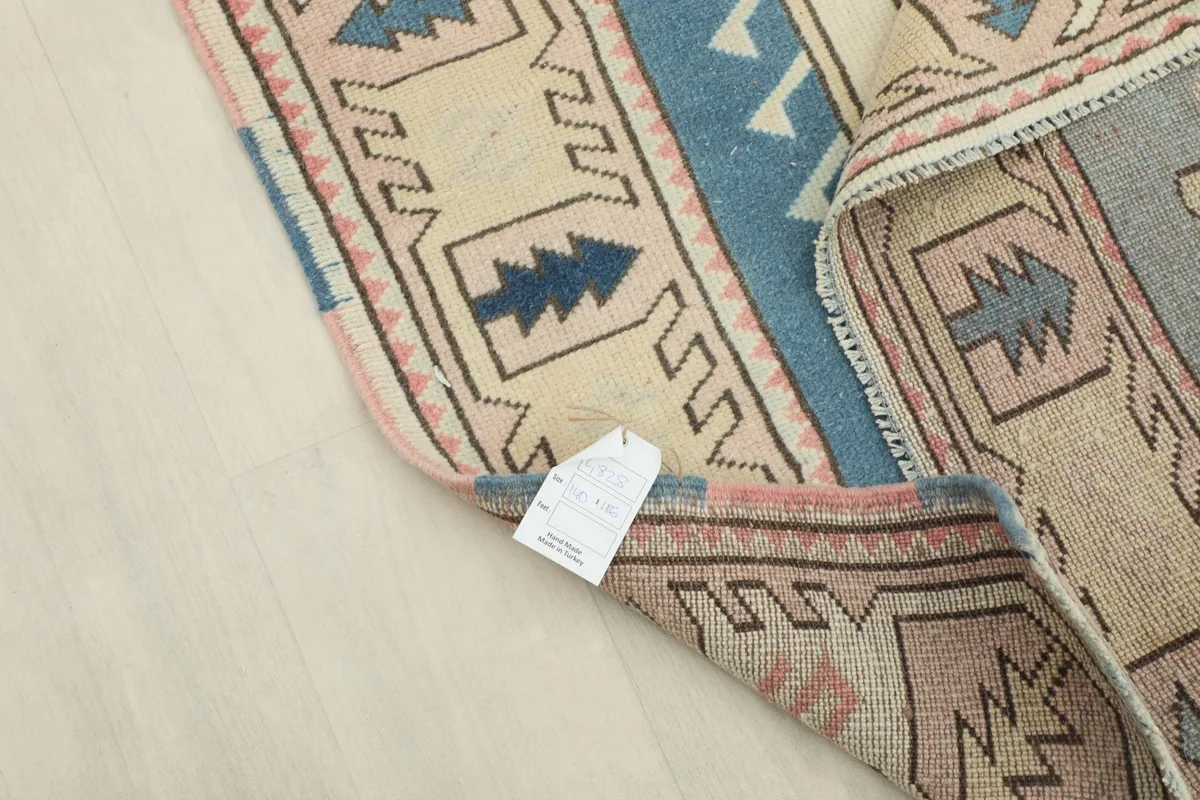 View of the rug's backside and label, indicating its hand-knotted craftsmanship.