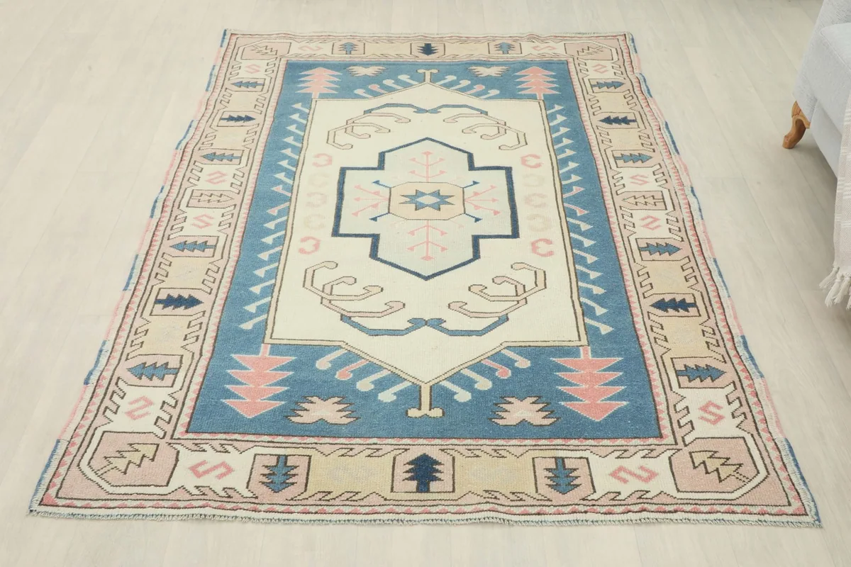 Full overhead view of the vintage rug in a room, showing its overall design and proportions.