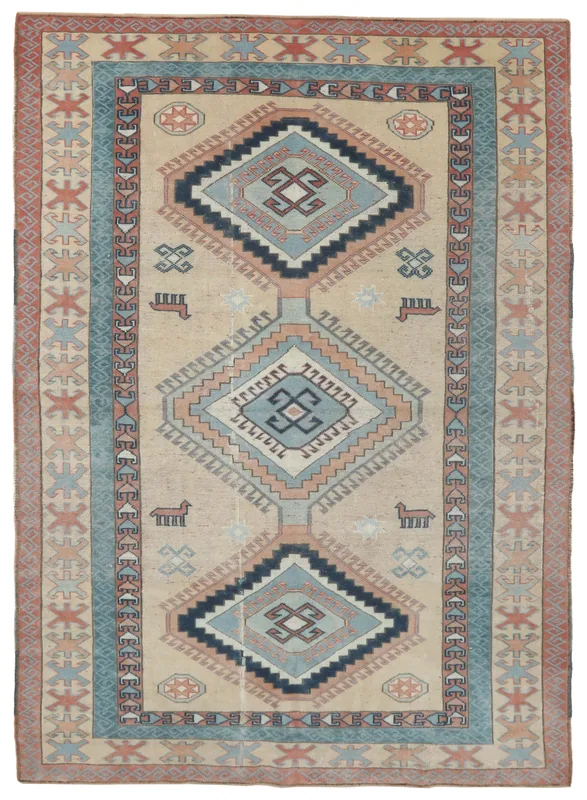 Full top view of the beige and blue vintage Anatolian rug with geometric patterns