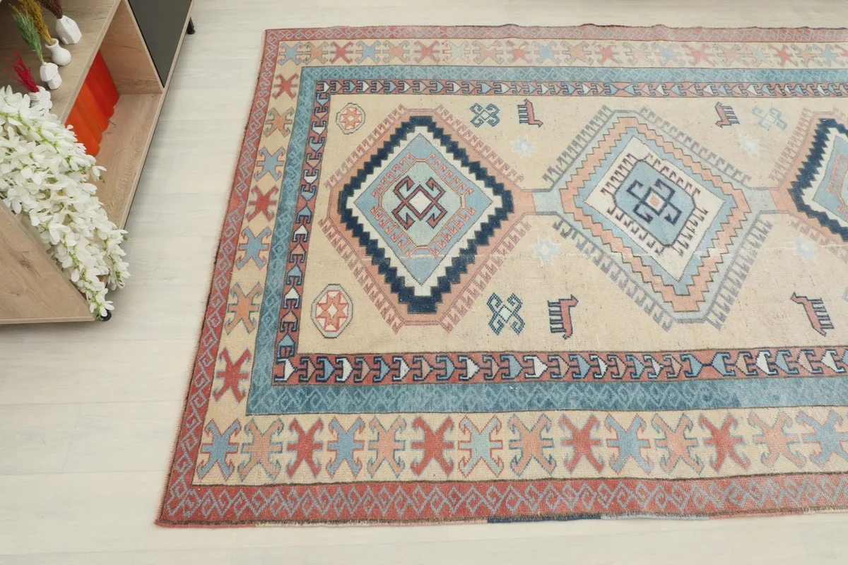 Overhead angle capturing the central medallions and border details of the vintage rug
