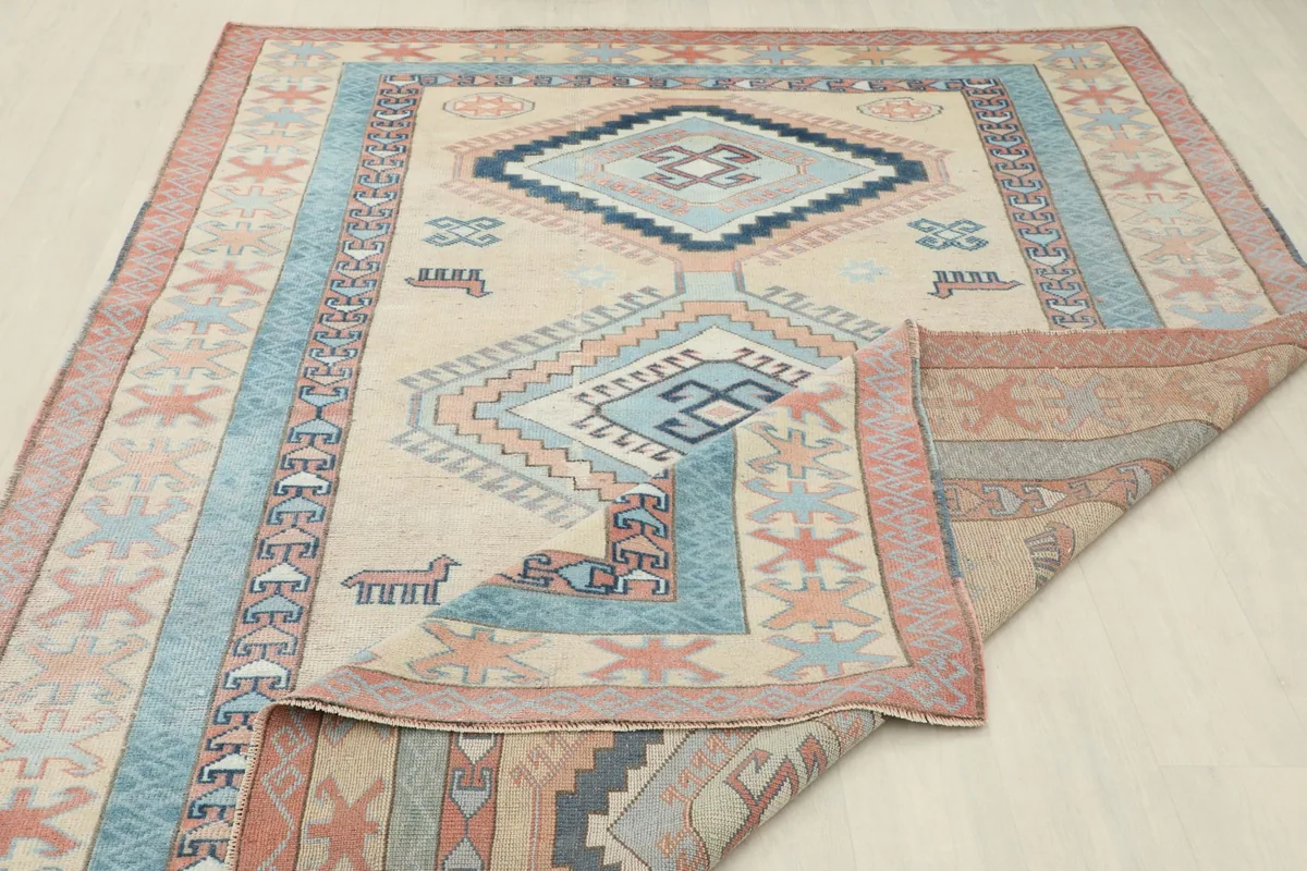 Rug corner folded to display the reverse side and the natural wool pile texture