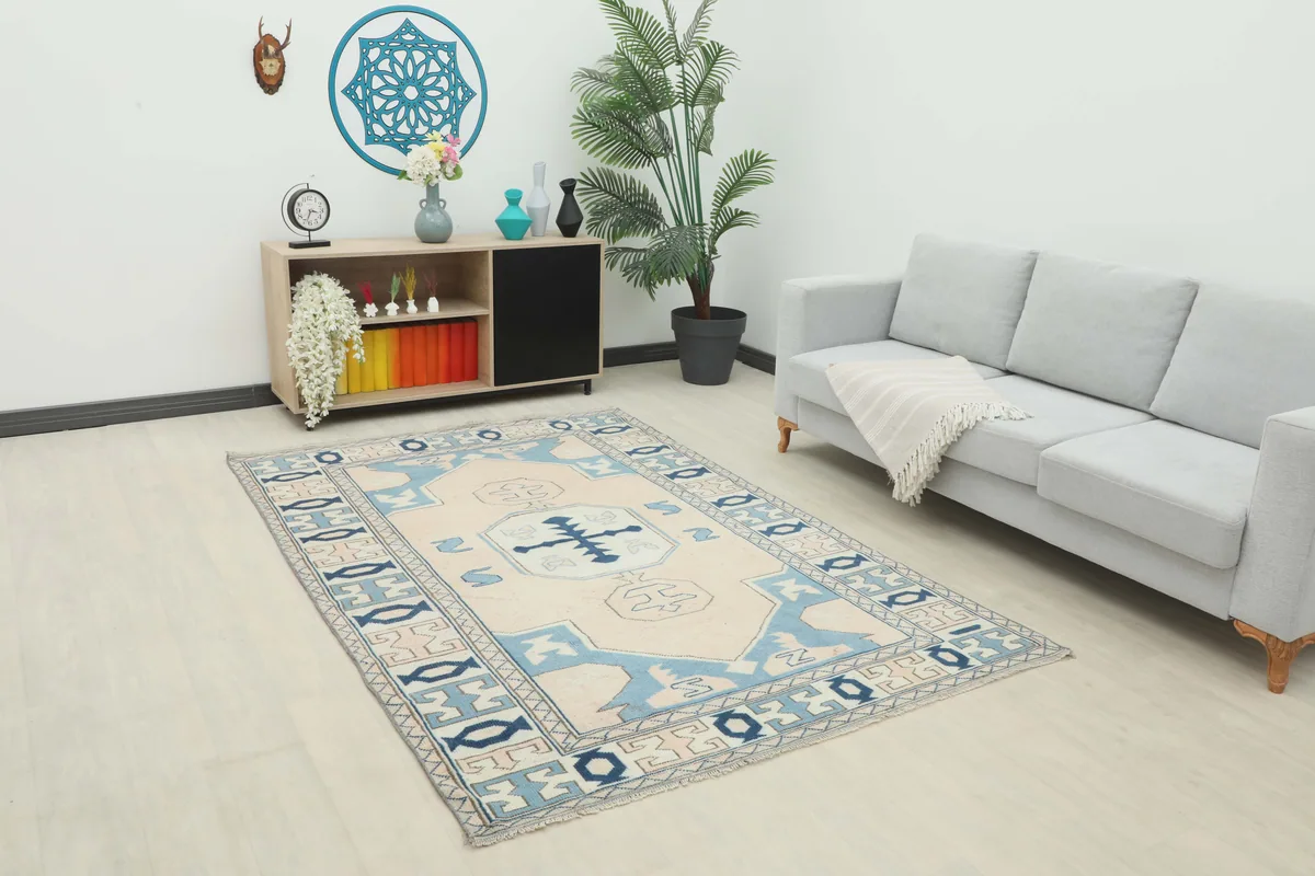 Cream Blue Geometric Anatolian Rug in a living room setting, viewed from an angle