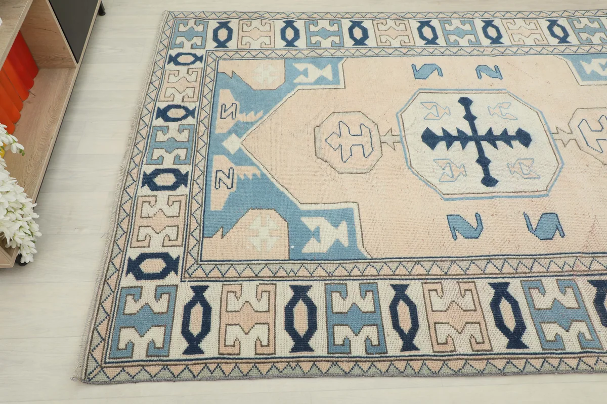 Cream Blue Geometric Anatolian Rug, angled view of the corner and part of the central design