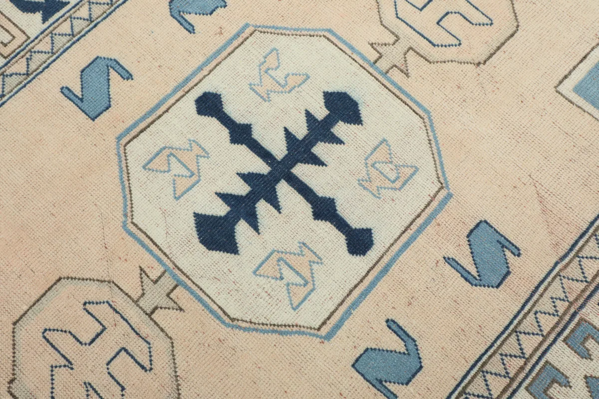 Detail of the central geometric motif on the Cream Blue Geometric Anatolian Rug