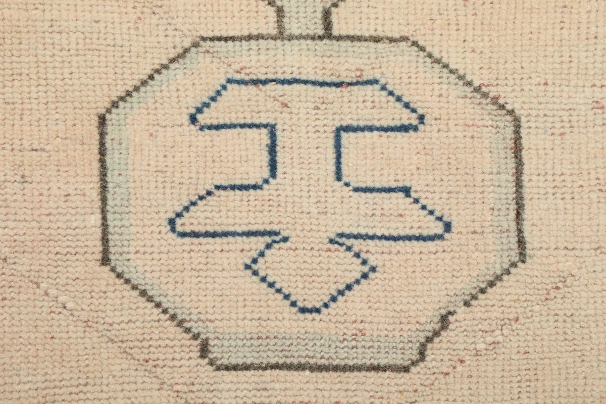 Close-up detail of a smaller geometric element within the Cream Blue Geometric Anatolian Rug