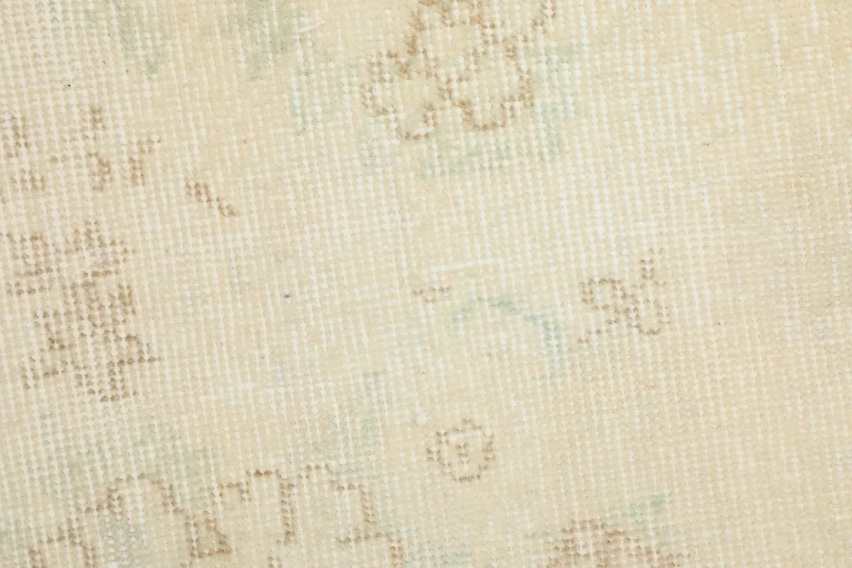 Close-up on the rug's texture, showing the individual knots and slight color shifts within the wool pile.