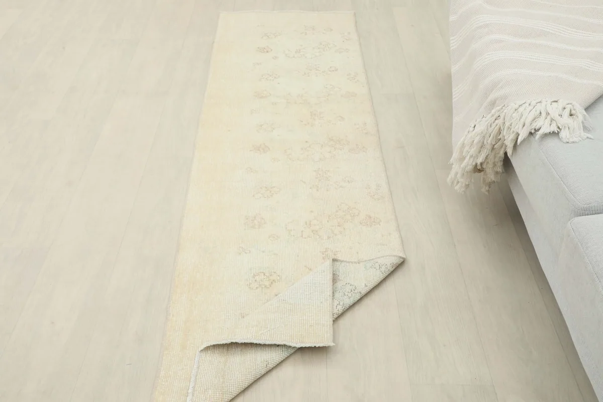 The runner rug partially folded, illustrating its flexibility and the overall design.