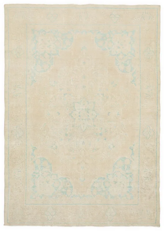 Full overhead view of the beige and blue vintage Anatolian rug on a white background.