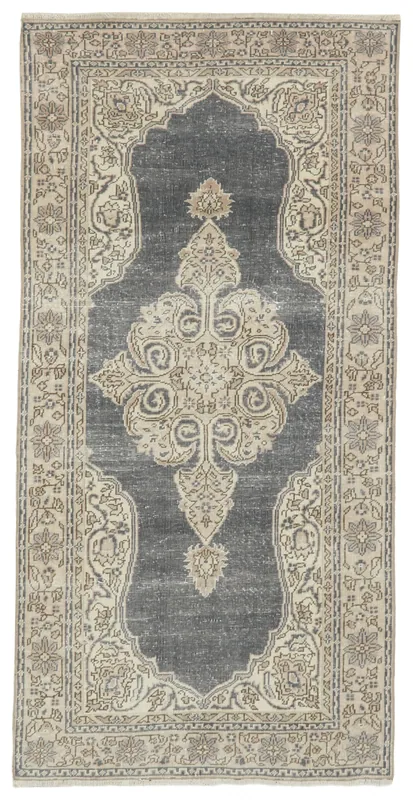 Full top view of the vintage charcoal and ivory medallion area rug on a white background.