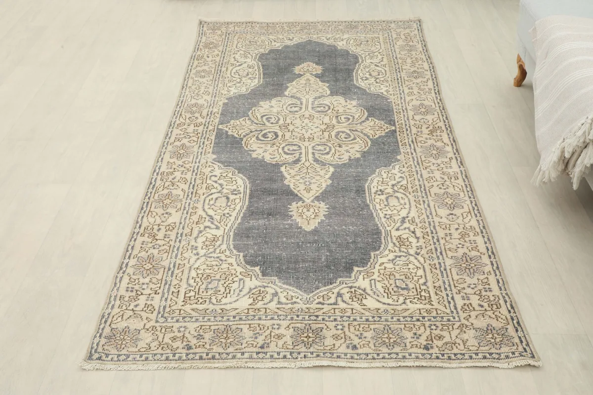 Full overhead view of the vintage rug, emphasizing its rectangular shape and overall design.