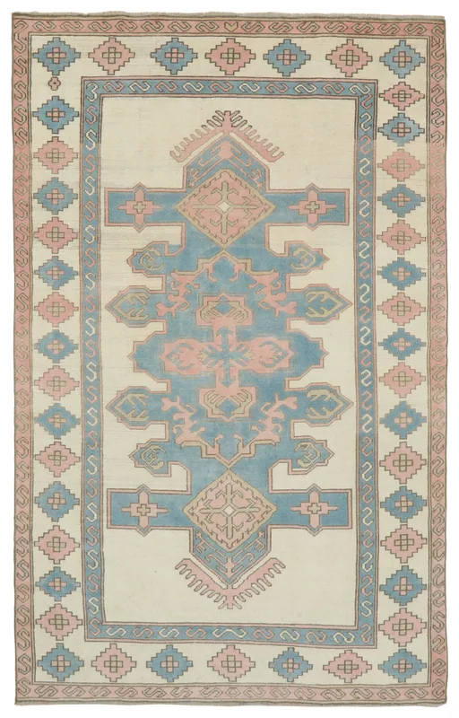 Full overhead view of the cream, blue, and pink vintage Anatolian rug