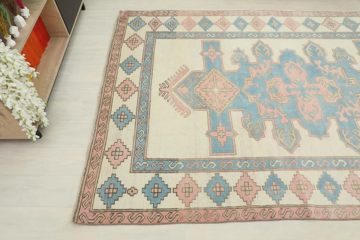Top-down angle view of the rug's pattern and colors next to a cabinet