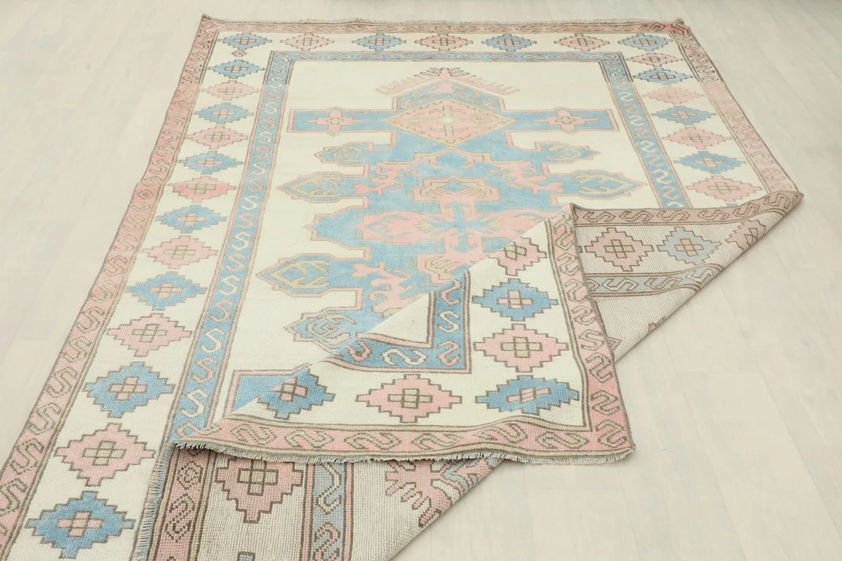 Rug partially folded, showing the back of the hand-knotted cotton foundation