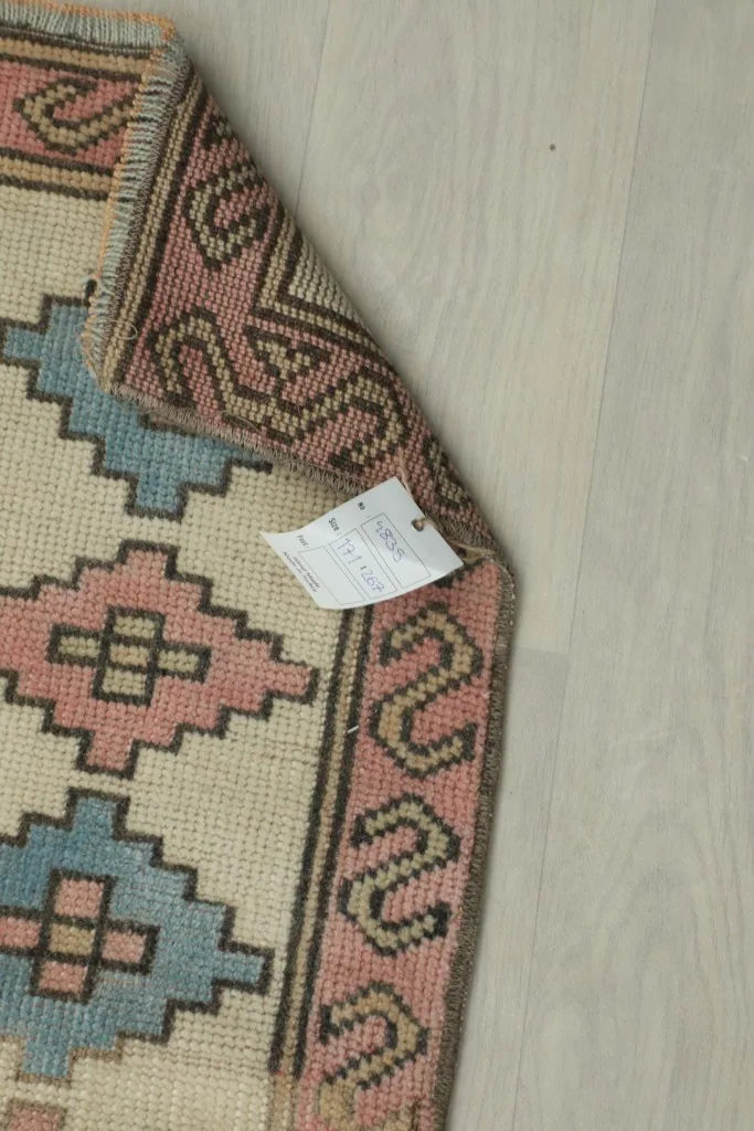 Corner of the rug with a label, showing the weave and fringe detail