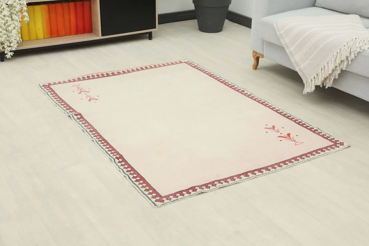 Overhead angle of the vintage rug in a living room, showing its placement relative to furniture
