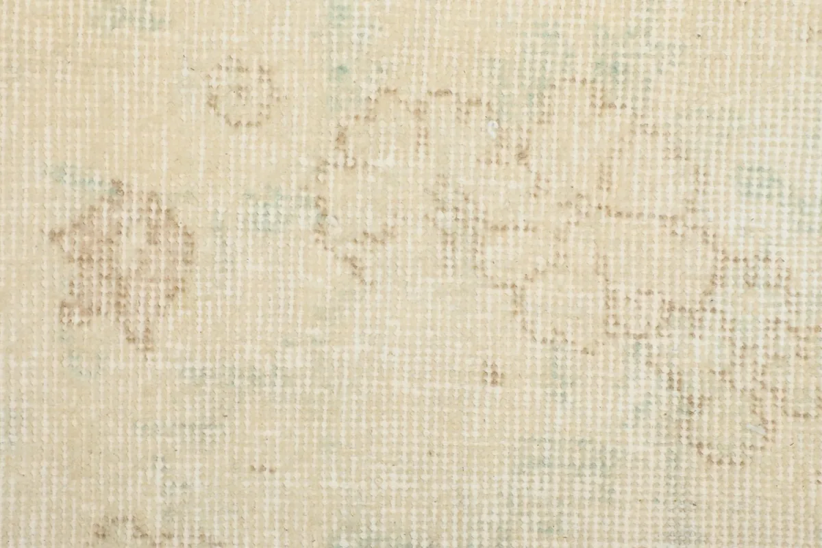Close-up of the low wool pile and hand-knotted texture, with visible subtle patterning.