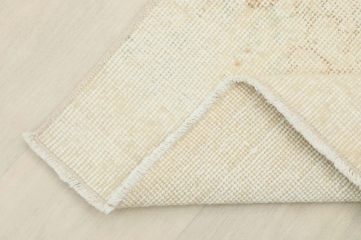 Underside of the rug, revealing the cotton foundation and fine hand-knotting.