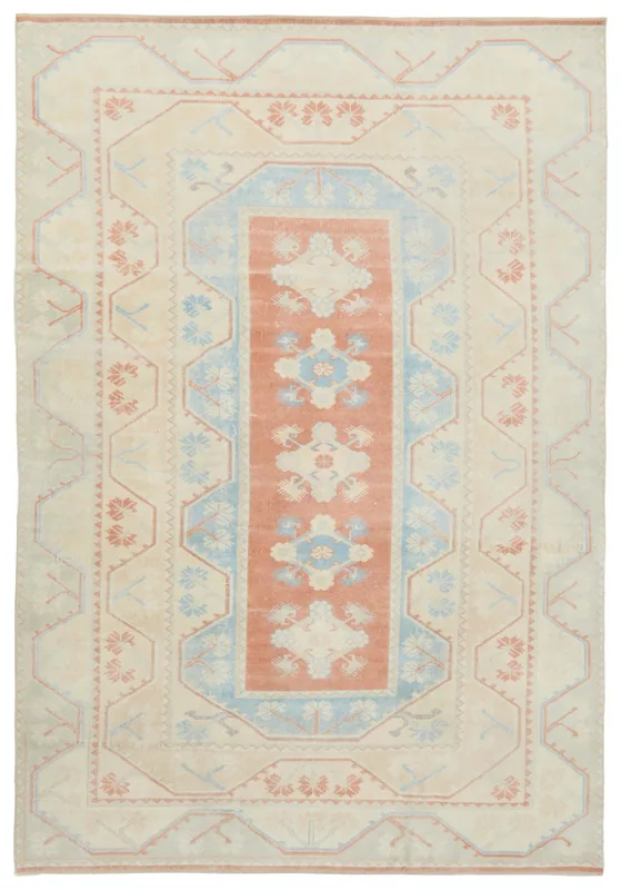 Full top view of the beige, rust, and blue vintage Anatolian rug on a white background.