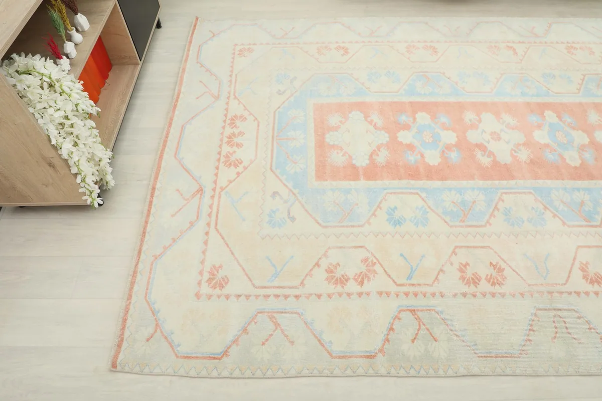 Angled view of the rug's pattern and colors, extending towards a console table.