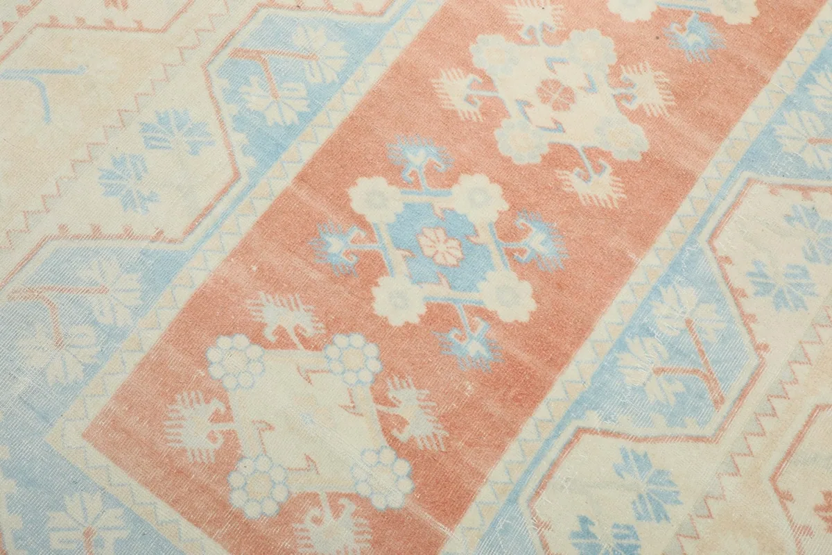 Detailed view of the central rust medallion and surrounding blue geometric patterns.
