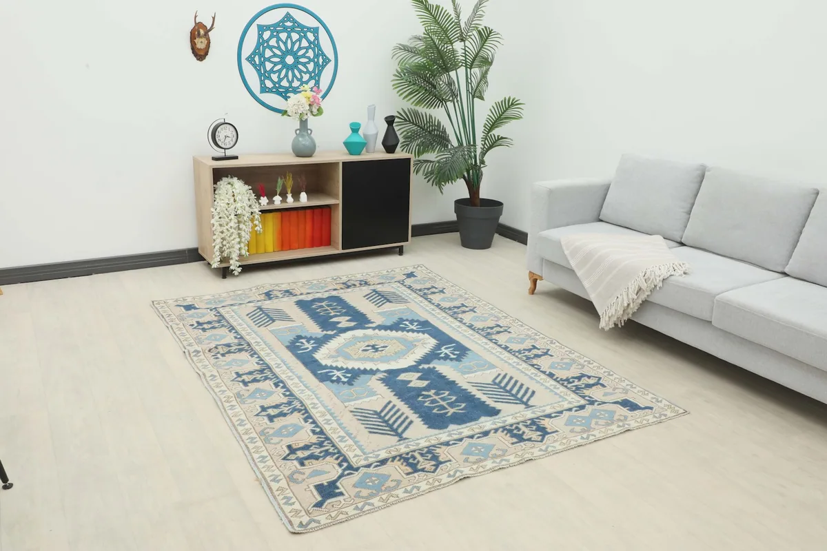 Vintage Anatolian rug displayed in a living room setting with a light sofa and wooden cabinet