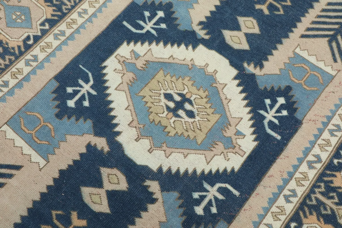 Detailed view of the central medallion design with sharp geometric shapes and contrasting colors