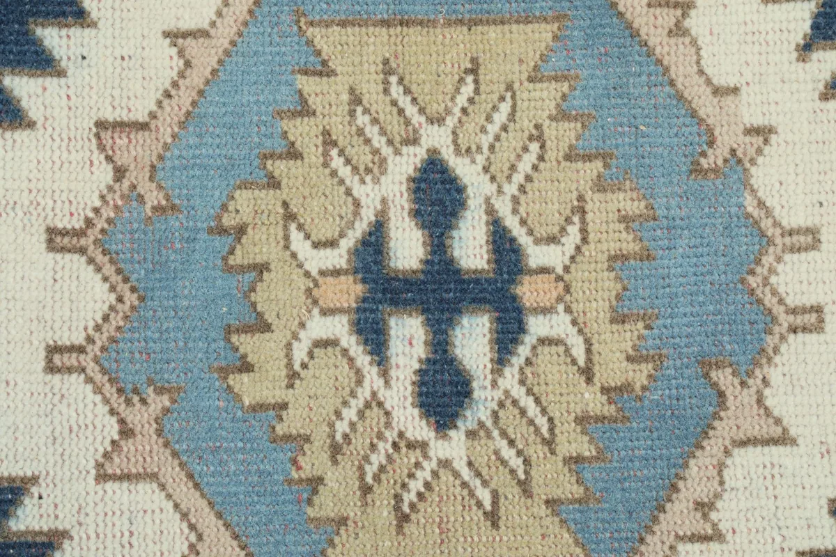 Extreme close-up of the central motif, showcasing the wool pile and knotting detail