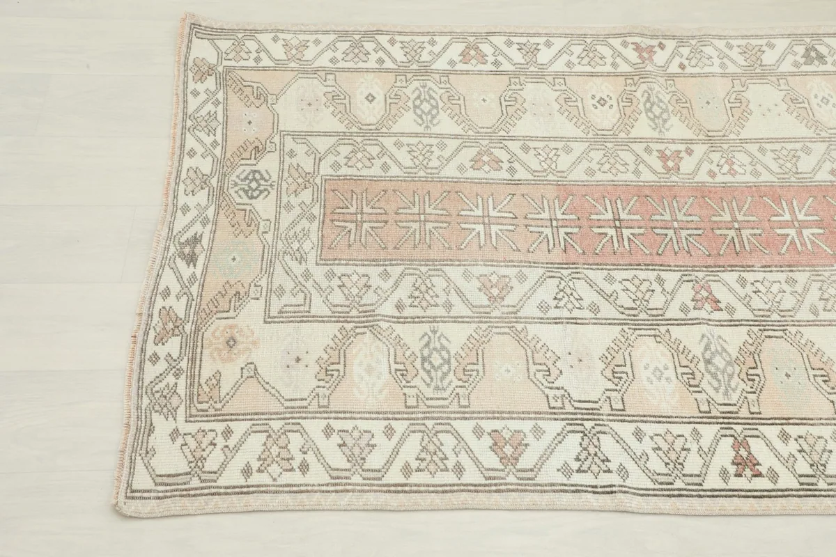 Overhead angled shot of the rug's top corner, revealing the intricate geometric patterns
