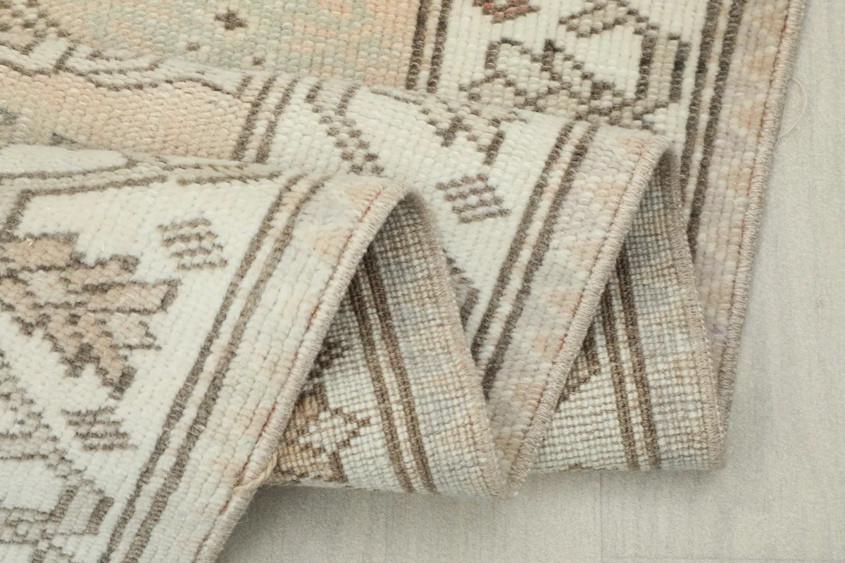 Close-up of the low wool pile and the tightly woven edge of the vintage rug
