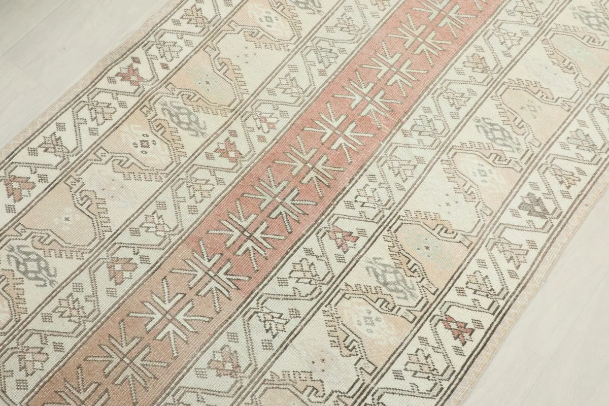 Overhead view focusing on the central rose stripe and surrounding ivory field patterns