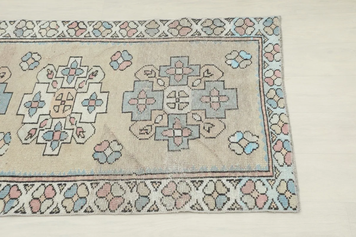 Close-up view of the upper right section of the rug, highlighting geometric patterns and border details.