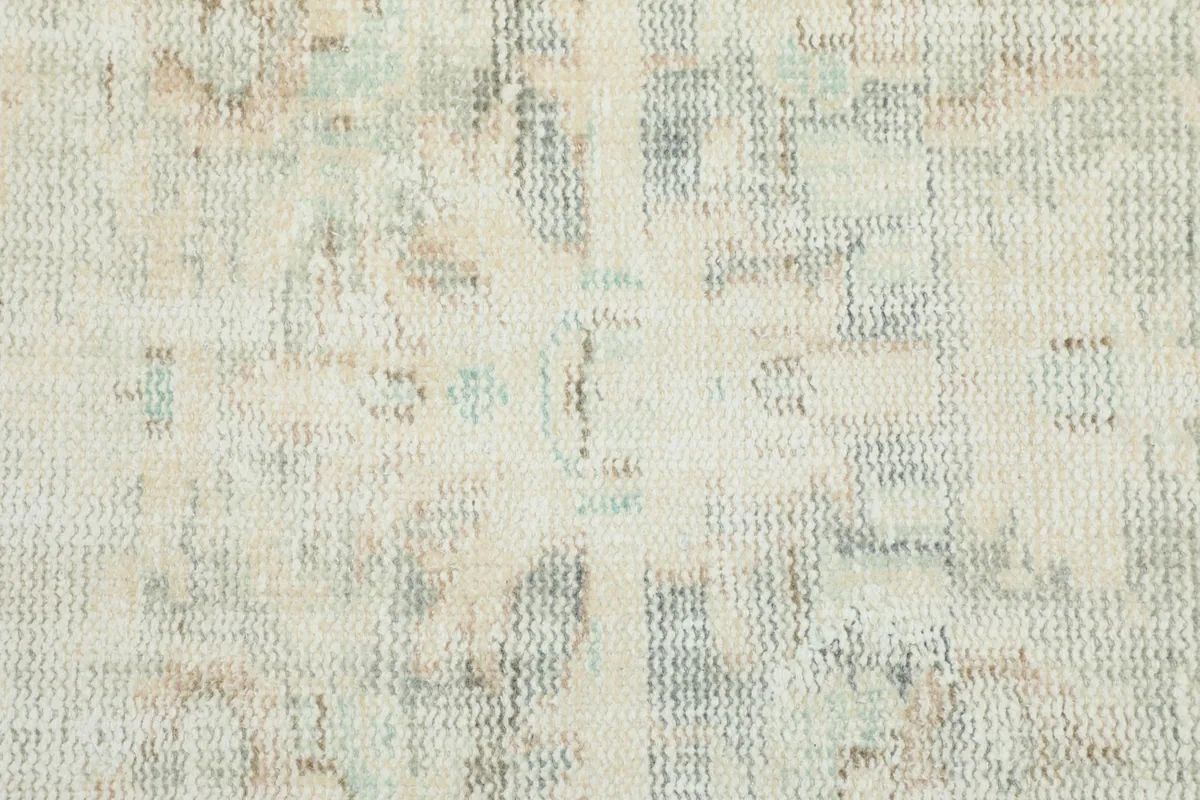 Texture of the low wool pile, highlighting the distressed appearance and soft color variations