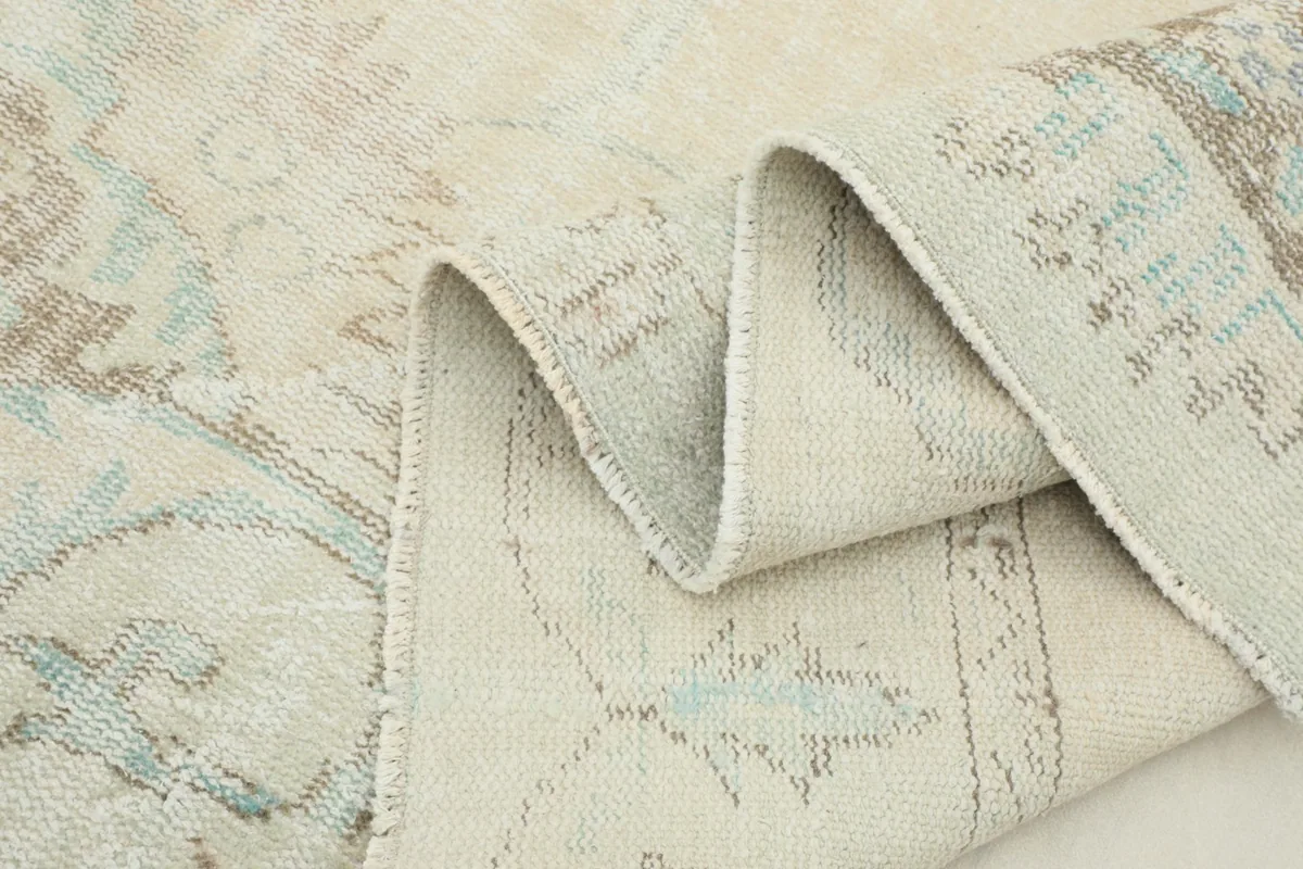 Side view of the rug showing its flexibility and the low pile height along a fold