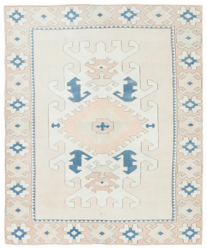 Full top view of the beige, rose, and blue geometric vintage Anatolian rug on a white background.