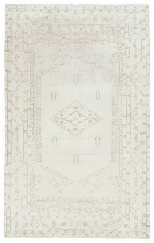 Full overhead view of the 5x9 vintage Anatolian rug with an ivory field and beige geometric medallion.