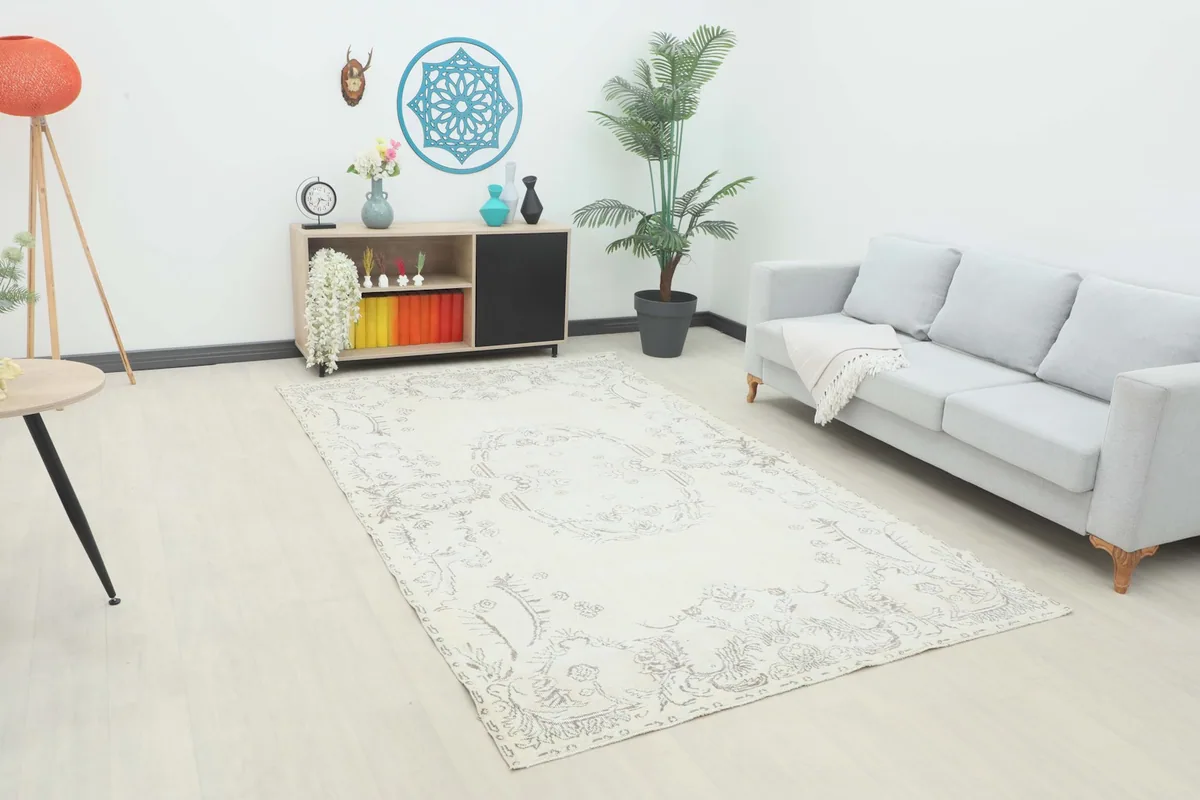 Vintage ivory and gray Anatolian rug displayed in a modern living room setting