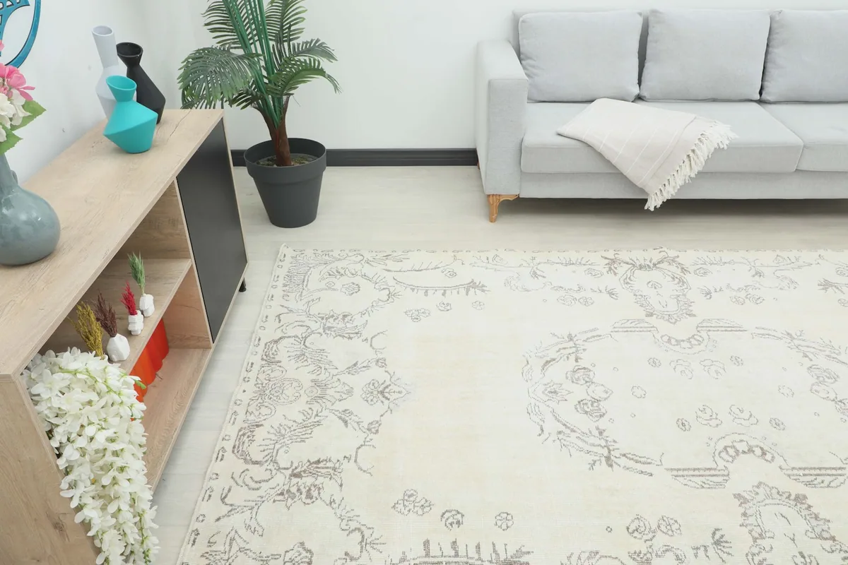 Angle view of the ivory area rug complementing a light-colored sofa and minimalist decor