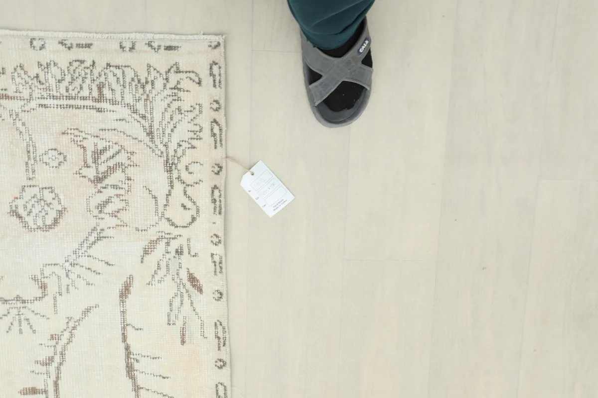 Overhead shot with a shoe for scale, emphasizing the rug's size and pattern details