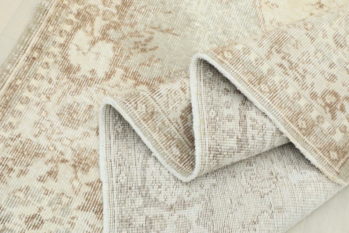 Rug folded to display the flexibility and thickness of the vintage hand-knotted construction.