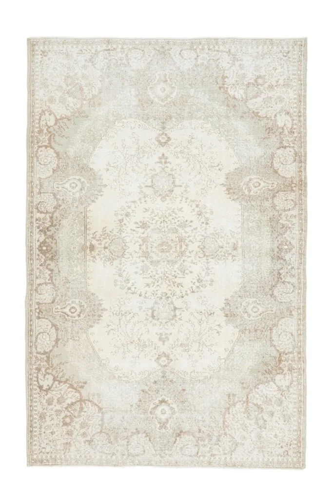 Full overhead view of the vintage ivory and beige area rug, showcasing its overall design.