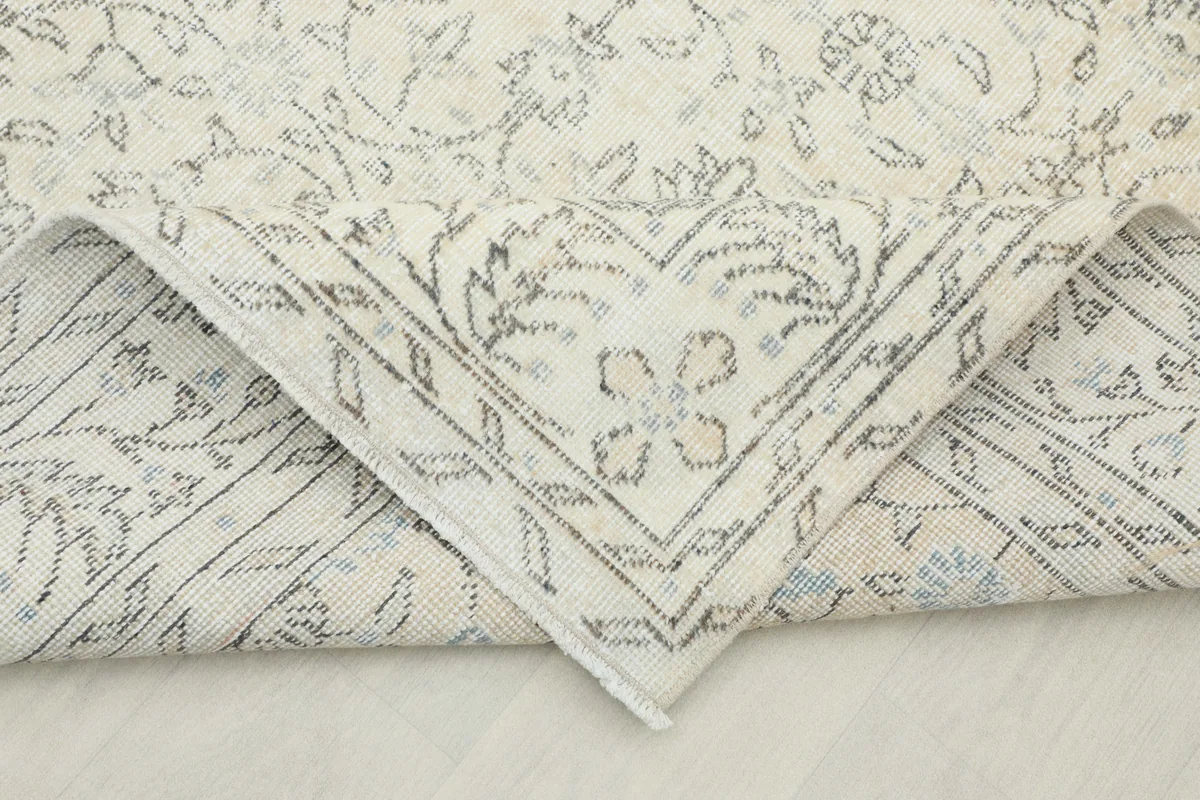Folded corner of the Beige Floral Anatolian Rug, showing the back and knotting detail.