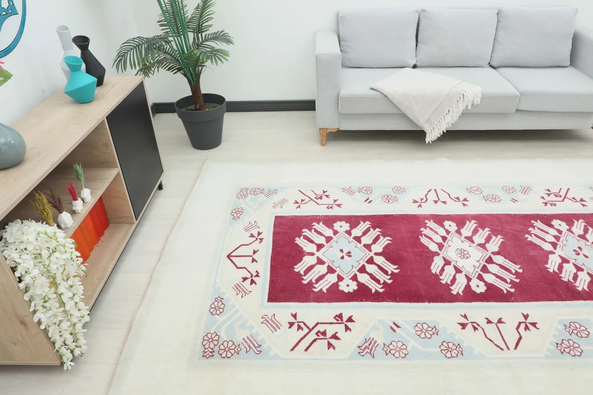 Overhead angle of the vintage rug in a living room, showing its placement relative to furniture