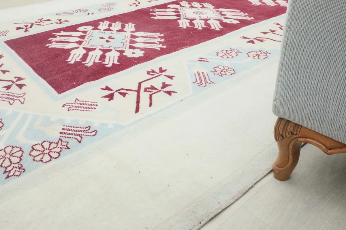 Rug placed next to a sofa leg, offering a sense of scale and room integration