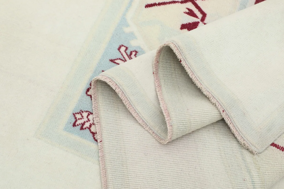 Close-up of the rug's edge and foundation, demonstrating its construction
