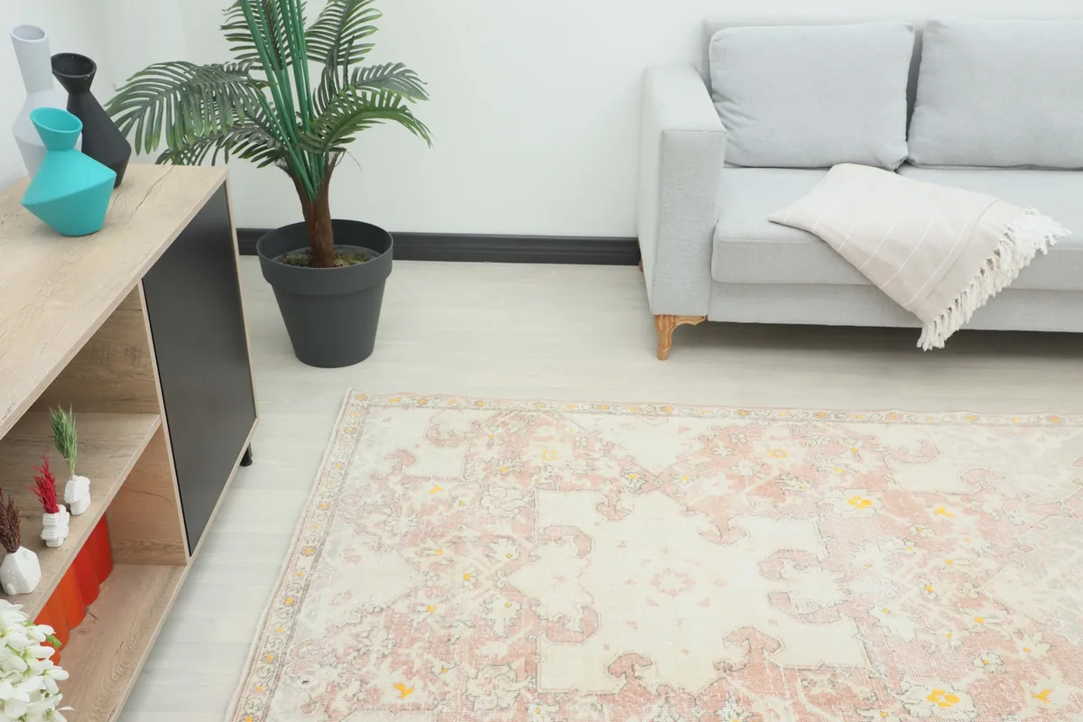 Overall view of the vintage rug placed in a modern living space with furniture.