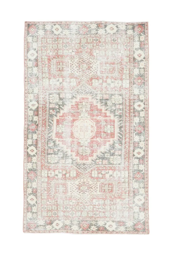 Full overhead view of the vintage red, gray, and ivory Anatolian rug on a white background