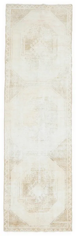 Full top view of the 3'0" x 10'2" beige and tan vintage Anatolian runner rug on a white background