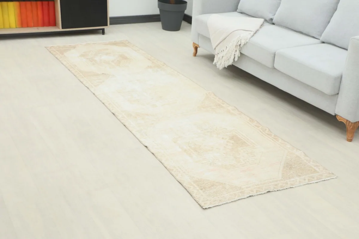 Angled view of the beige and tan runner rug showcasing its length in a modern living space