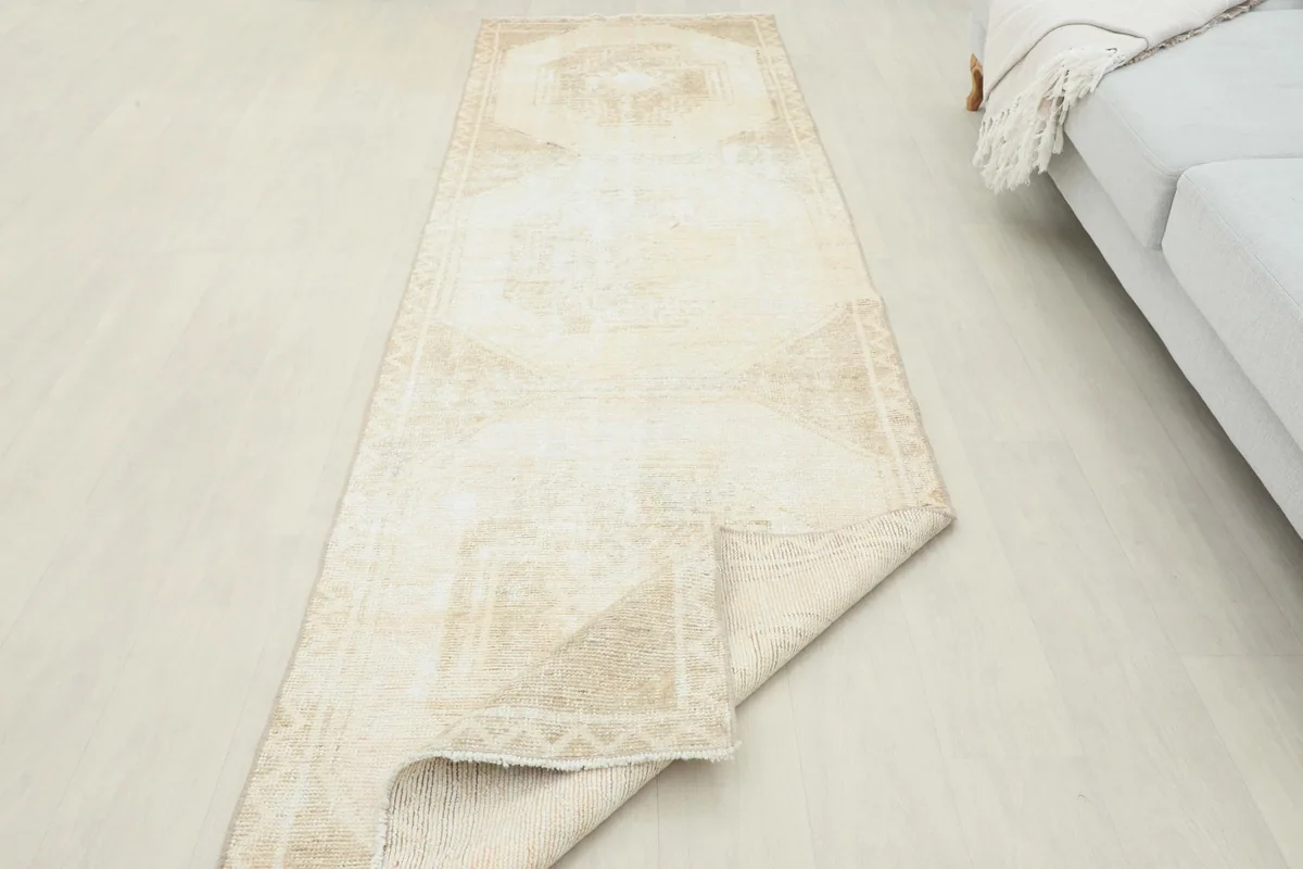 Angled view of the runner rug with one end slightly folded, highlighting its flexible structure