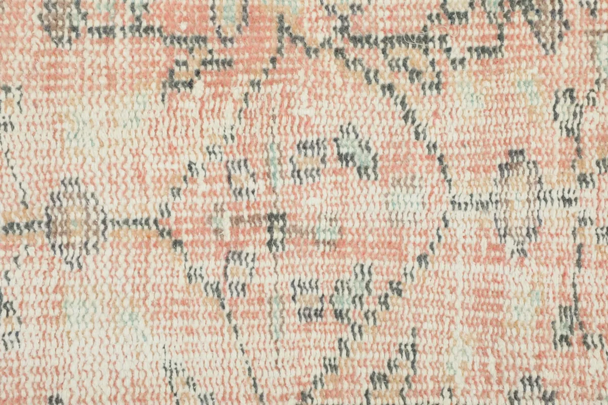 Extreme close-up of the low wool pile and intricate tribal geometric knotting